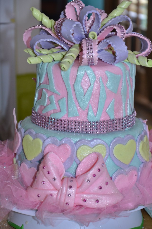The back of this birthday cake has a oversized fondant bow with sparkles.  Special order your birthday cake at By Grace Cakes bakery, Bay City, MI.