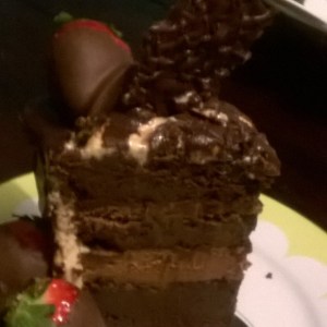 Flourless chocolate cake filled with whipped chocolate mousse, covered in peanut butter butter cream and drizzled with chocolate ganache. Don't forget about the chocolate covered strawberries!! Order now at By Grace Cakes!